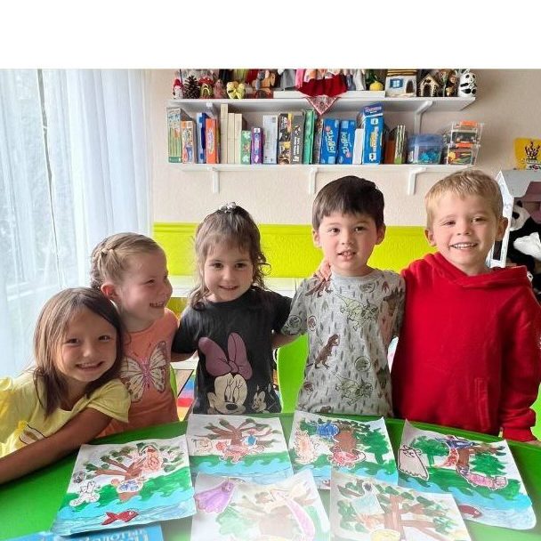 Children showing their Golden Fish drawings