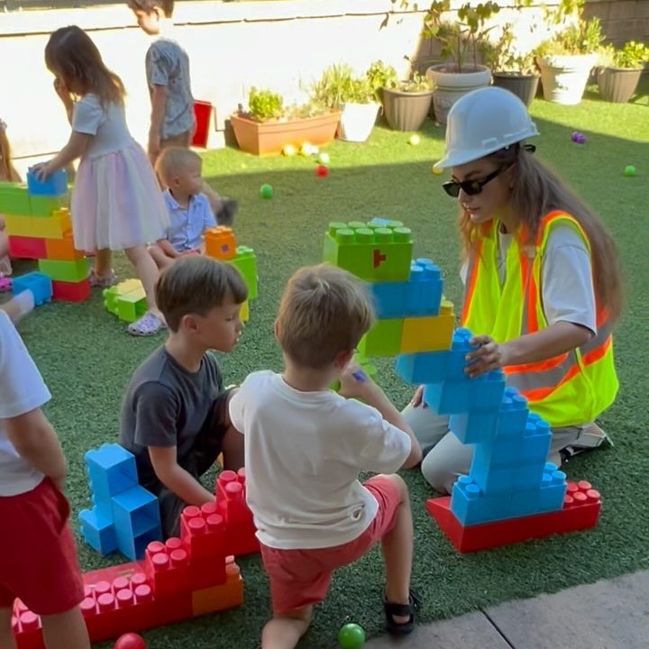 Kids building with big blocks in the backyard